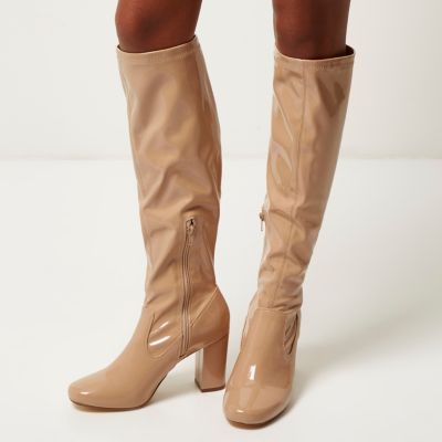 Light beige patent heeled knee high boots